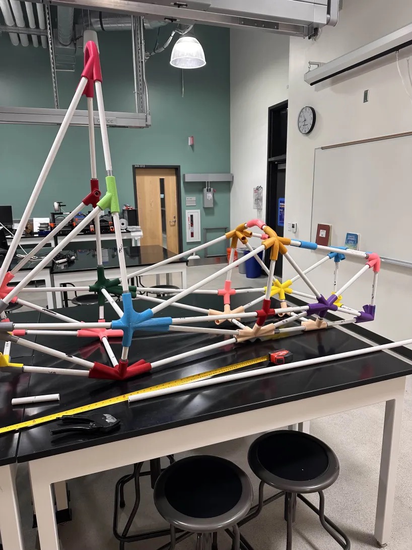 A race car structure, pipes linked by colorful connectors.