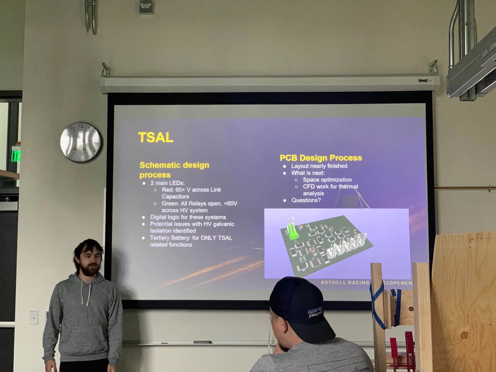 Students in front of a purple slide presentation.
