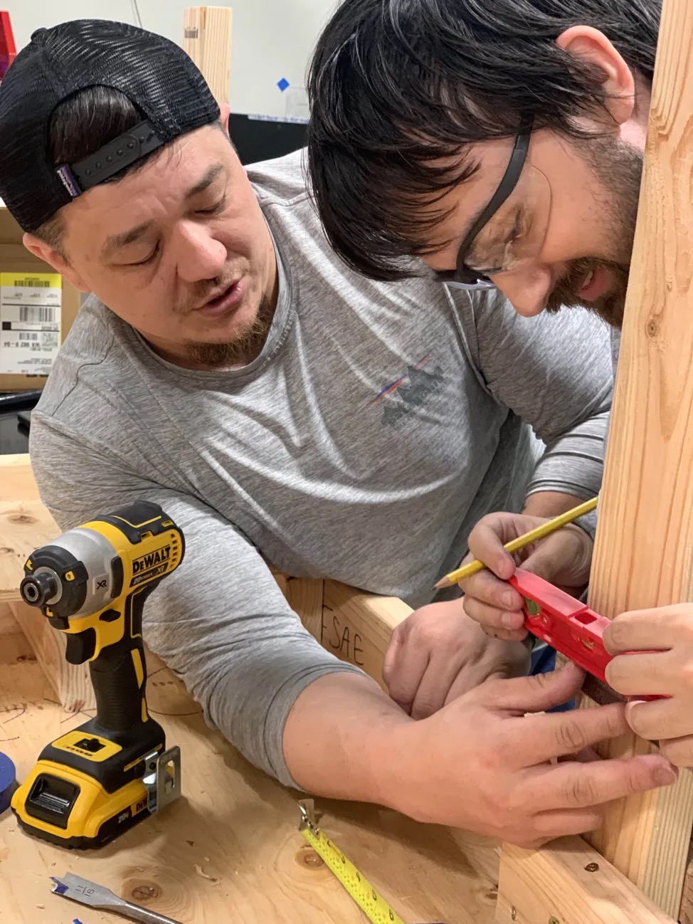 Two people taking measurements.